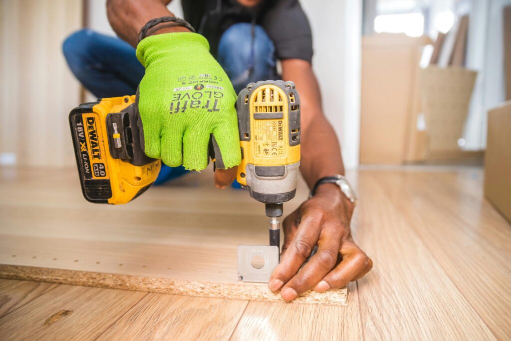 pexels-photo-1249611 Person Using Dewalt Cordless Impact Driver on Brown Board